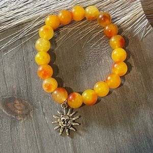 Orange Jade stretch bracelet with sun charm